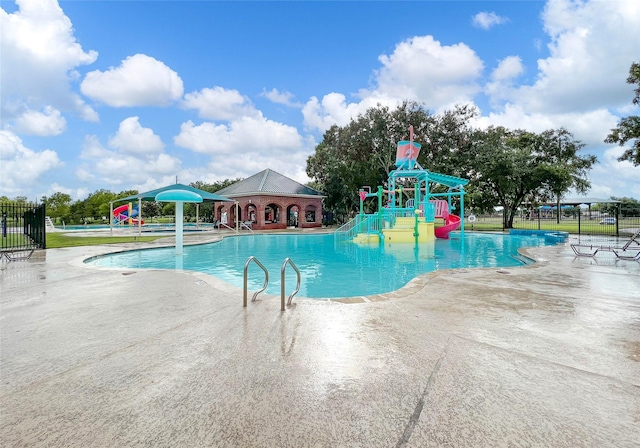 view of pool with a patio area and a water slide