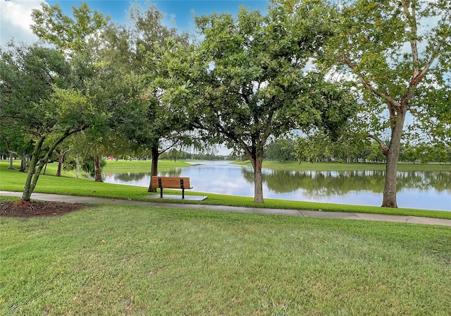 view of property's community featuring a yard and a water view