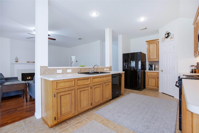 kitchen with ceiling fan, sink, backsplash, light tile patterned floors, and black appliances