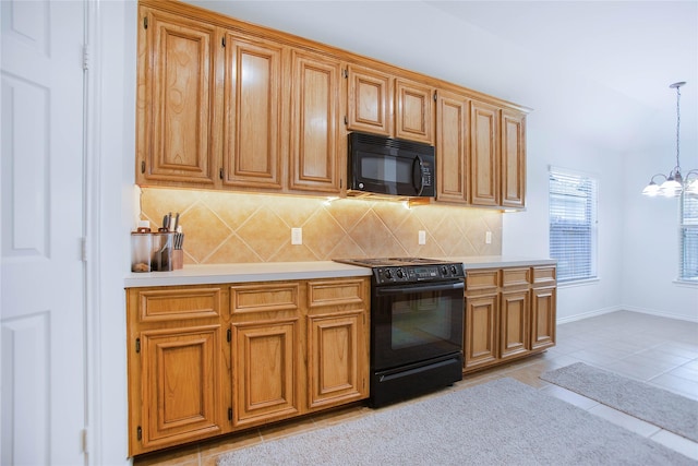 kitchen with decorative backsplash, light tile patterned flooring, hanging light fixtures, and black appliances