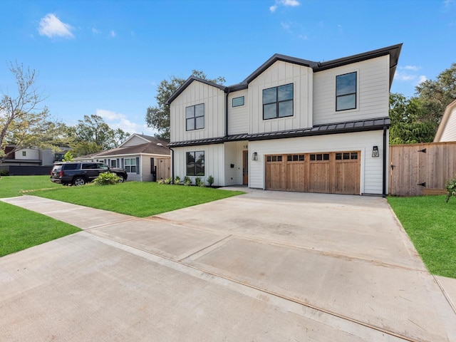 modern inspired farmhouse with a front yard and a garage