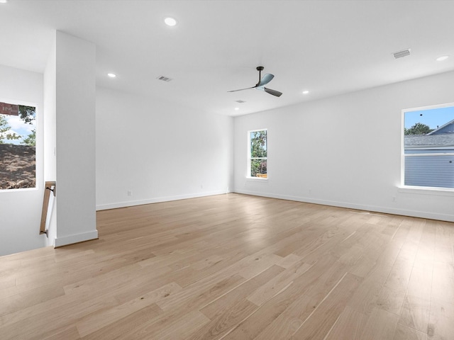 unfurnished room with ceiling fan and light wood-type flooring