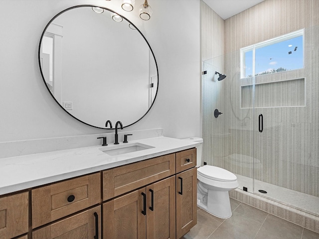 bathroom with tile patterned flooring, vanity, toilet, and a shower with shower door