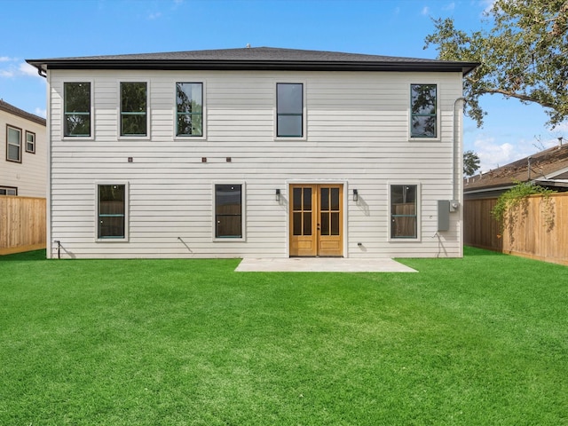 back of house featuring a patio and a lawn