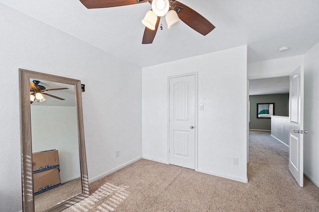 unfurnished bedroom with ceiling fan and light colored carpet