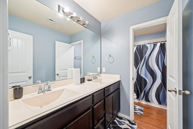 bathroom with hardwood / wood-style flooring, vanity, toilet, and a shower with curtain