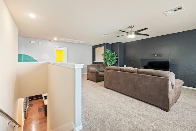 carpeted living room with ceiling fan