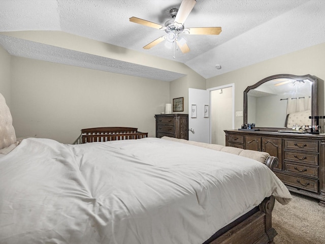 carpeted bedroom featuring ceiling fan, a textured ceiling, and vaulted ceiling