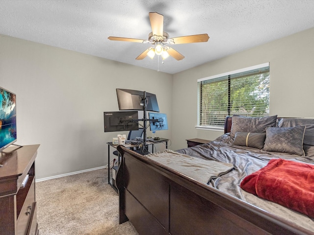 carpeted bedroom featuring a textured ceiling and ceiling fan