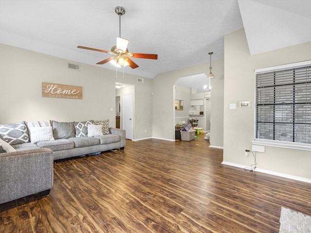 living room featuring ceiling fan and dark wood-type flooring