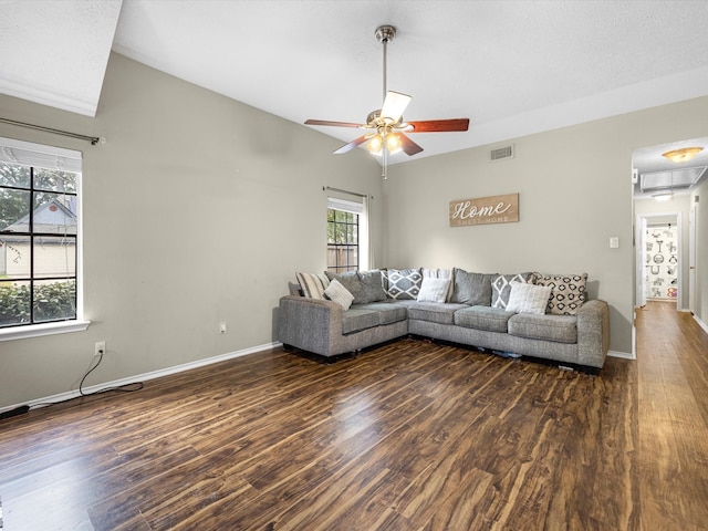 living room featuring lofted ceiling, ceiling fan, and dark hardwood / wood-style floors