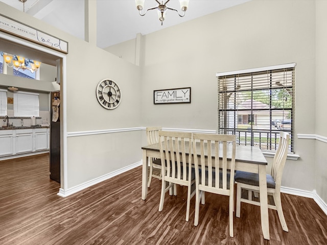 dining room featuring a chandelier, dark hardwood / wood-style flooring, high vaulted ceiling, and beamed ceiling