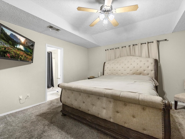 bedroom with ceiling fan, carpet floors, ensuite bathroom, and a textured ceiling