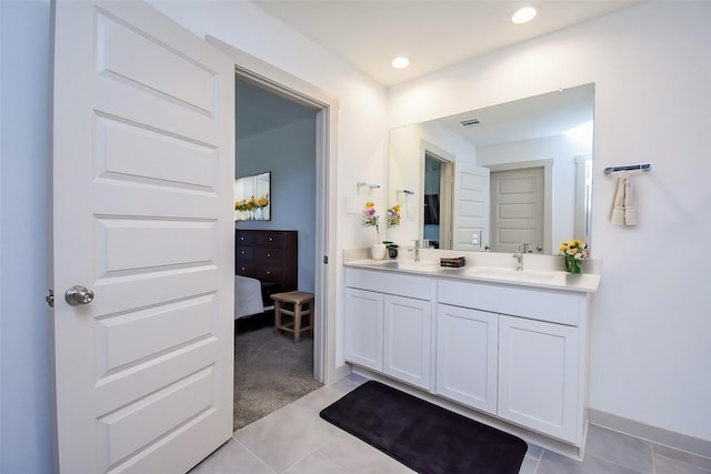 bathroom featuring tile patterned flooring and vanity