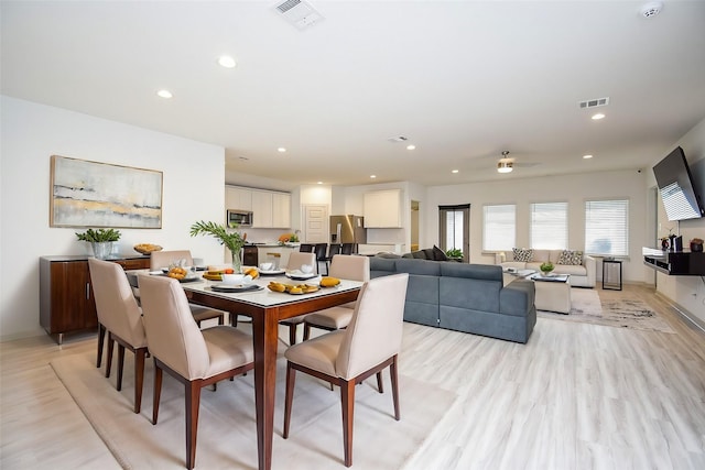 dining area featuring light hardwood / wood-style floors and ceiling fan