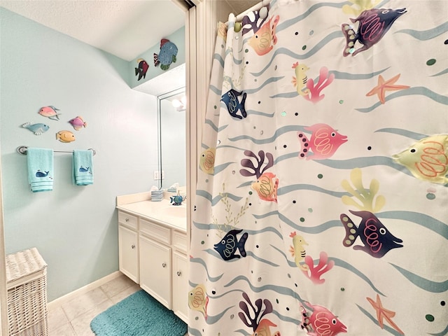 bathroom featuring vanity, a textured ceiling, and tile patterned floors