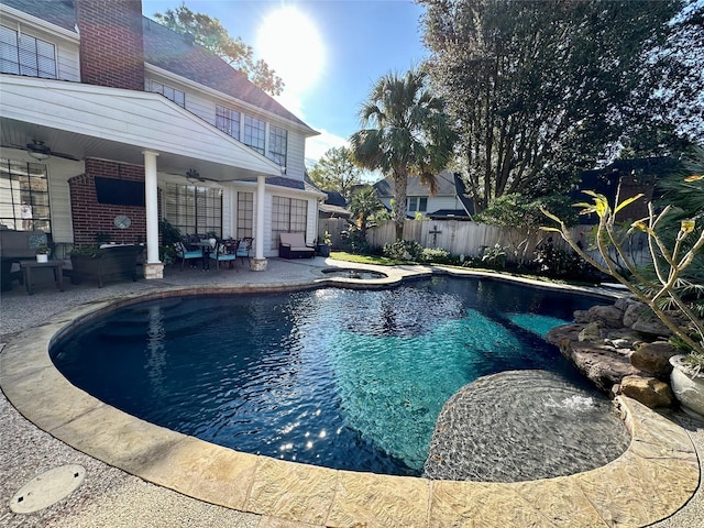 view of swimming pool featuring an in ground hot tub, a patio, and ceiling fan