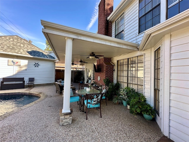 view of patio / terrace with ceiling fan and a swimming pool