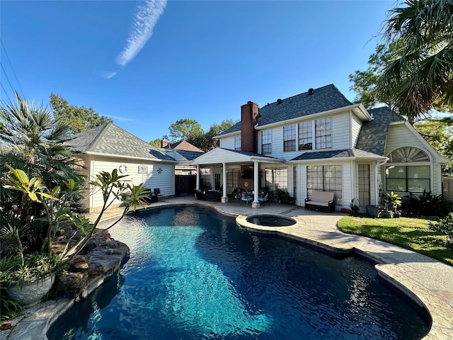 view of swimming pool featuring an in ground hot tub and a patio