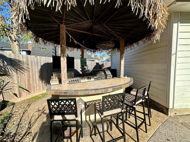 view of patio / terrace featuring an outdoor kitchen and exterior bar