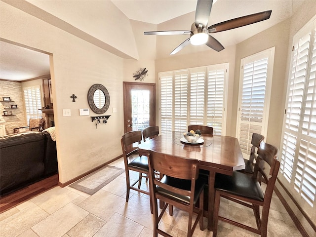 dining space with ceiling fan and lofted ceiling