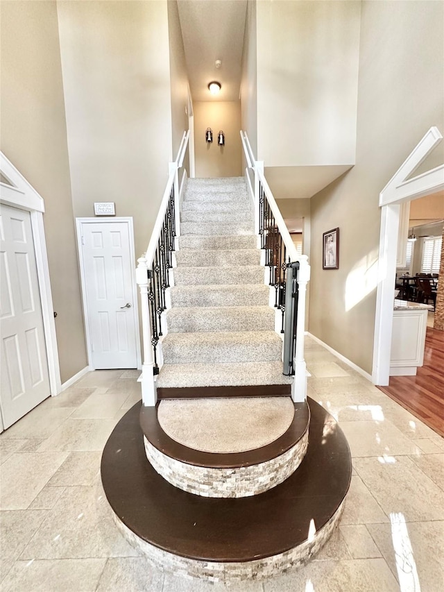 stairs featuring a towering ceiling