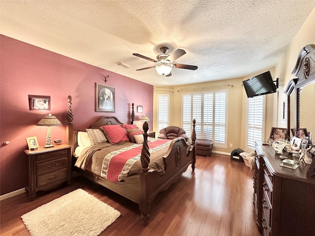 bedroom featuring a textured ceiling, ceiling fan, and dark wood-type flooring