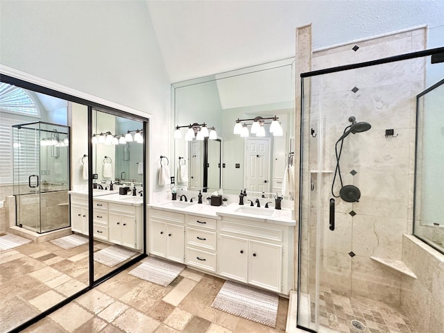 bathroom featuring vanity, lofted ceiling, and walk in shower