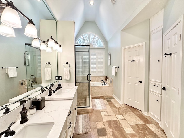 bathroom with vanity, vaulted ceiling, and shower with separate bathtub