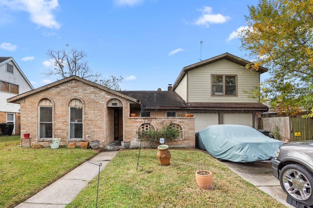 view of front of home with a front lawn and a garage