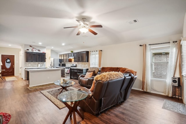 living room featuring ceiling fan and dark wood-type flooring