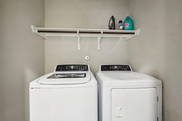 washroom featuring washing machine and dryer