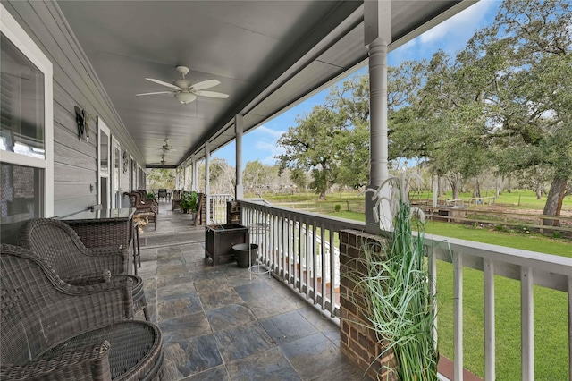 view of patio with ceiling fan and a porch