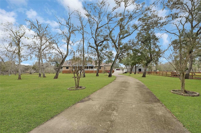 view of property's community with a yard