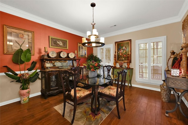 dining area featuring dark hardwood / wood-style flooring, ornamental molding, and a notable chandelier