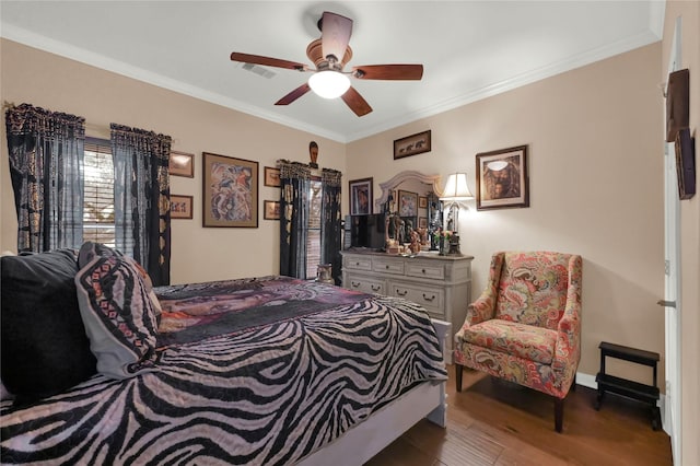 bedroom featuring hardwood / wood-style flooring, ceiling fan, and ornamental molding