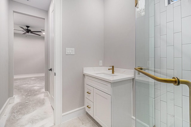 bathroom featuring ceiling fan, a shower with shower door, and vanity