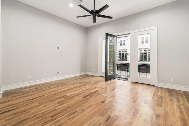 spare room featuring french doors, ceiling fan, and light hardwood / wood-style floors