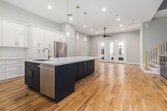 kitchen with sink, white cabinetry, ceiling fan, an island with sink, and appliances with stainless steel finishes