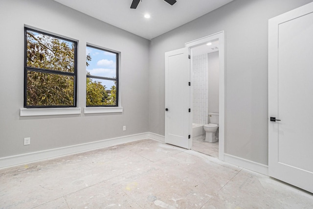 unfurnished bedroom featuring connected bathroom and ceiling fan