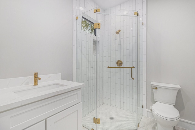 bathroom featuring toilet, an enclosed shower, tile patterned floors, and vanity