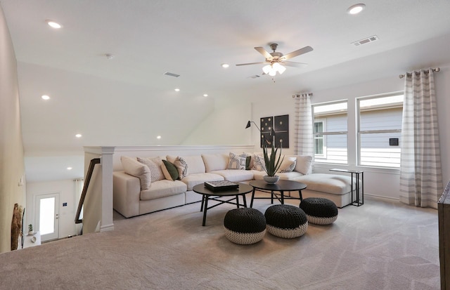 living room with ceiling fan, light colored carpet, and lofted ceiling