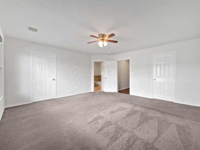 unfurnished bedroom with dark carpet and ceiling fan