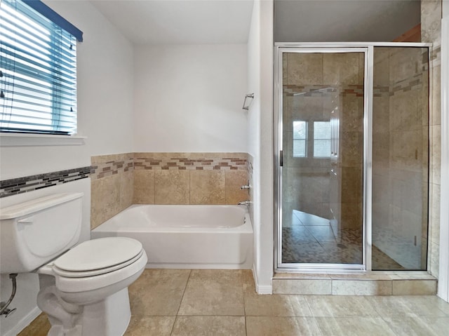 bathroom featuring tile patterned floors, separate shower and tub, and toilet