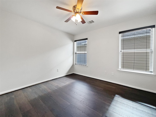 unfurnished room featuring ceiling fan and dark hardwood / wood-style flooring