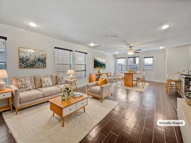 living room with hardwood / wood-style flooring, ceiling fan, and crown molding