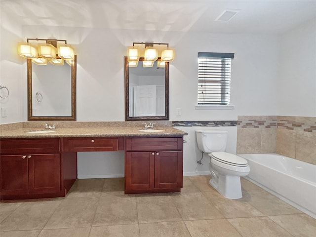 bathroom with tile patterned floors, a bathing tub, vanity, and toilet