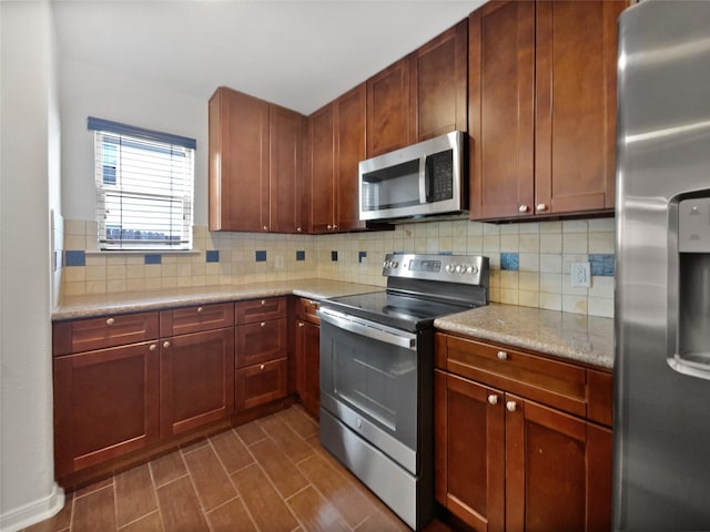 kitchen featuring tasteful backsplash, light stone countertops, and stainless steel appliances