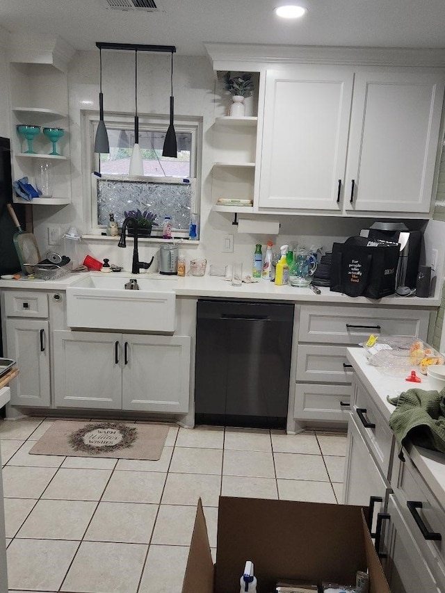 kitchen featuring sink, light tile patterned floors, decorative light fixtures, black dishwasher, and white cabinetry