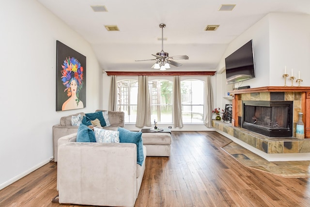 living room with ceiling fan, wood-type flooring, and lofted ceiling